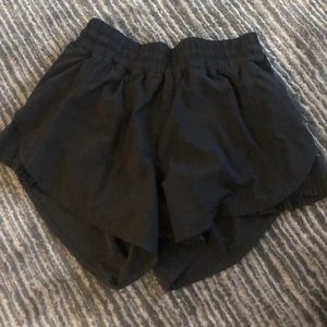 Black lululemon shorts with ruffle detail on sides